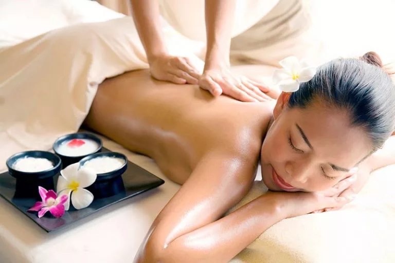 Therapist giving back massage at a condo in Thao Dien